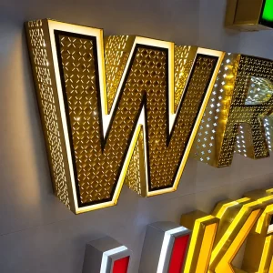 Custom Gold LED Channel Letter Sign Perforated Metal Face White Border Halo Backlit Wall Mounted Storefront Logo