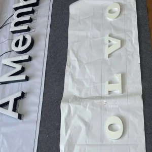 White Spray Painted 304 Stainless Steel PC Board with White Film Applied Signage for Chain Brands and Chain Store Identity